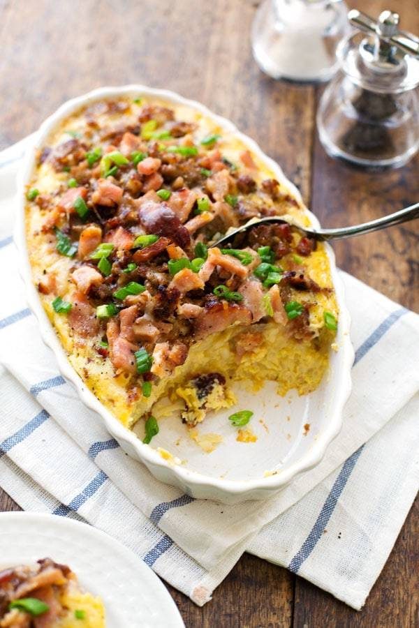 Ham and Sausage Hash Brown Egg Bake with a spoon.