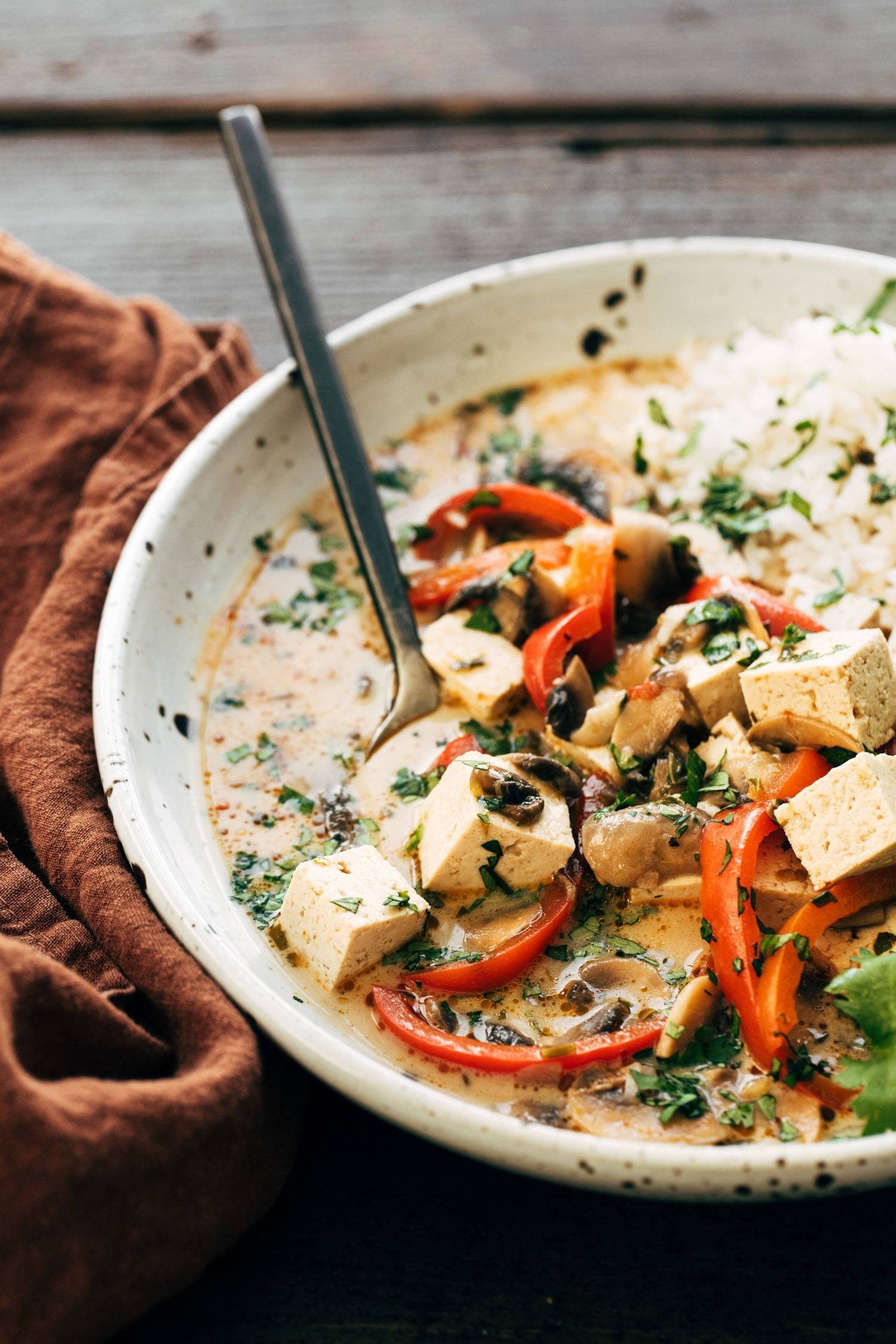 Thai Coconut Soup in a bowl with tofu and rice.