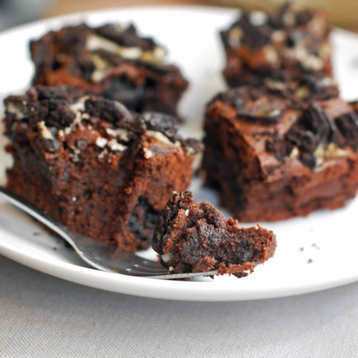 Oreo brownies on a white plate with a fork.