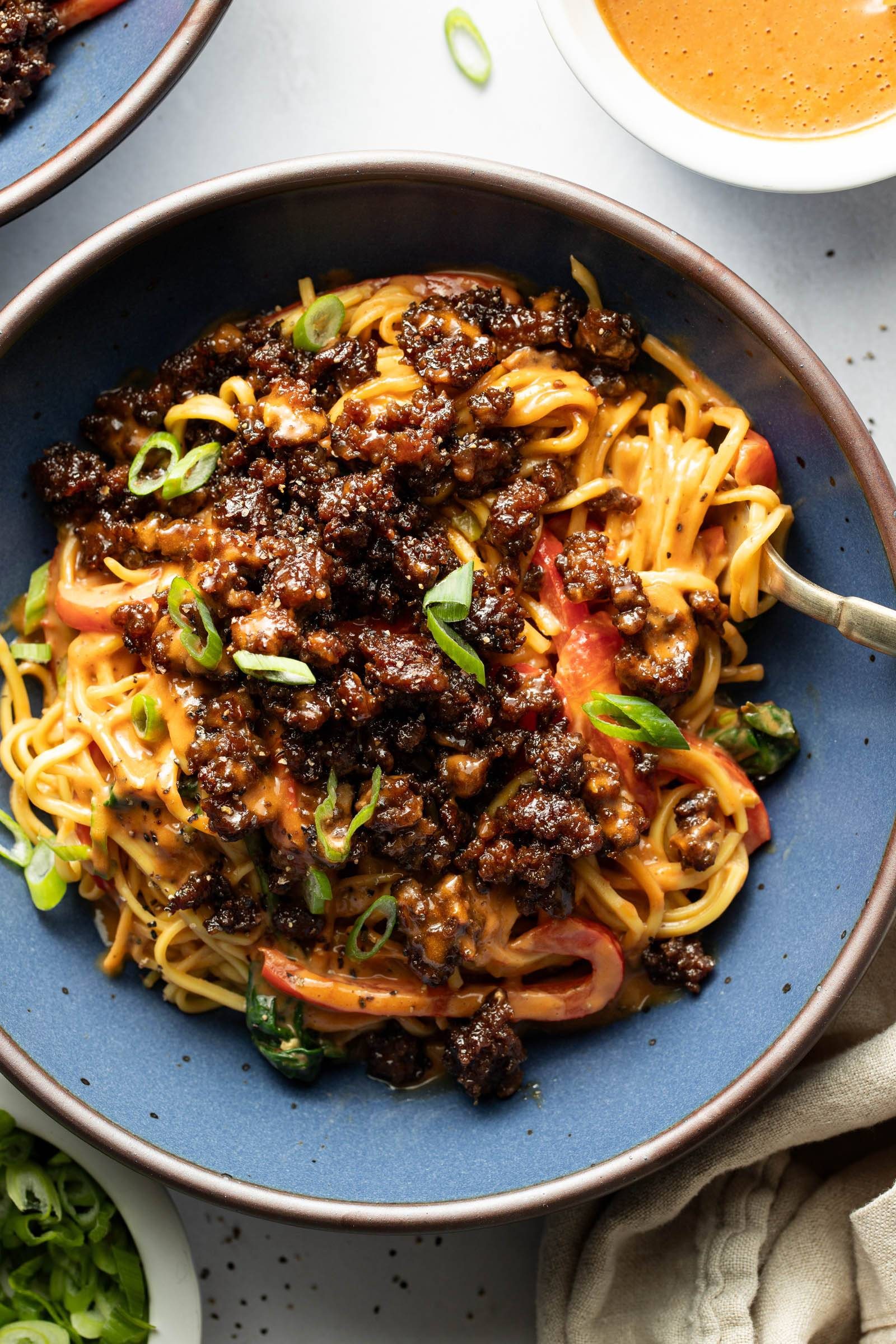 Peanut noodles with ground beef on top.
