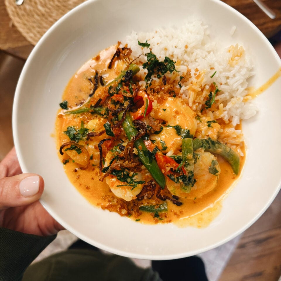 Shrimp curry in a bowl with rice.