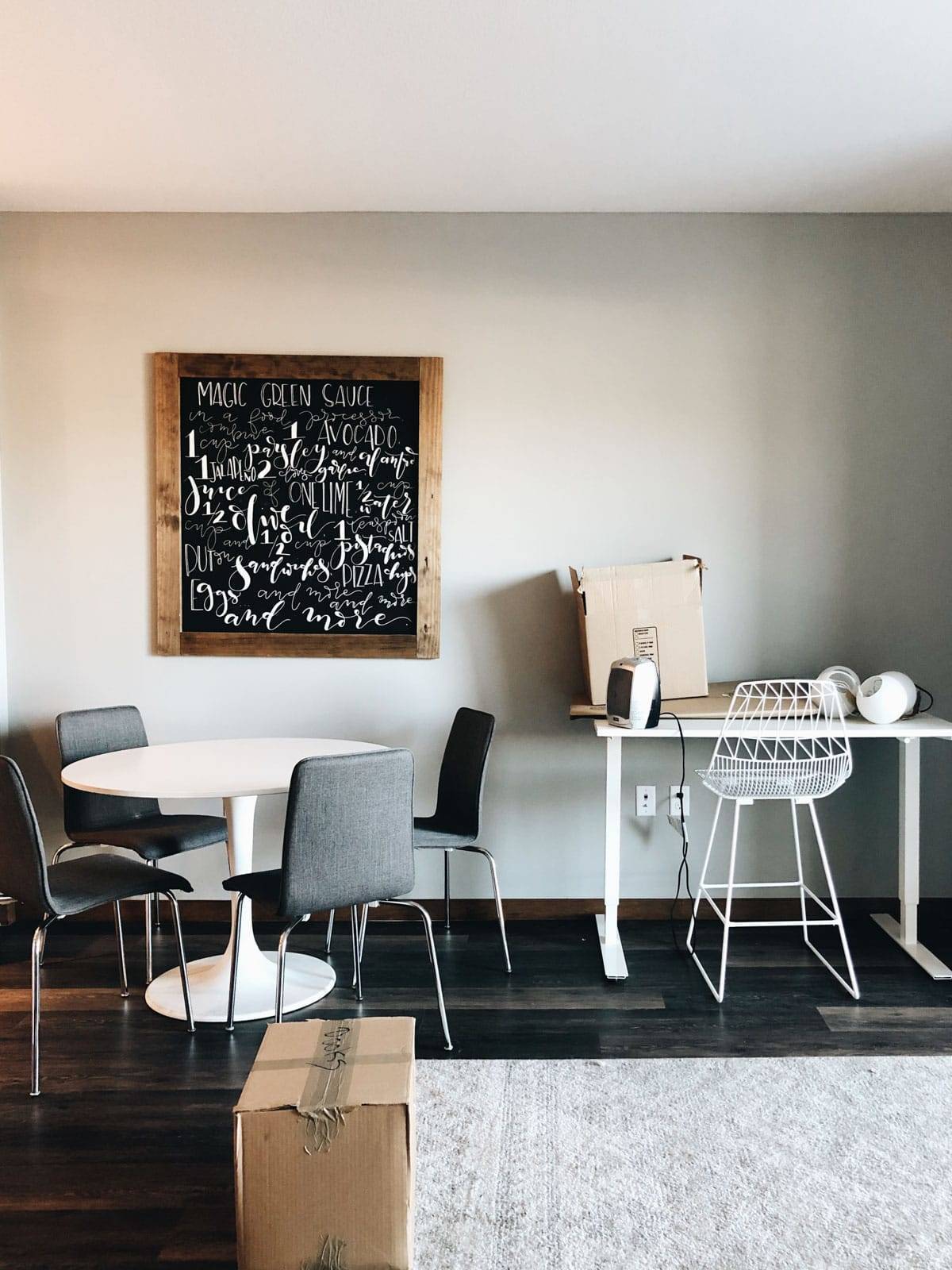 A dining area with a chalkboard on the wall.