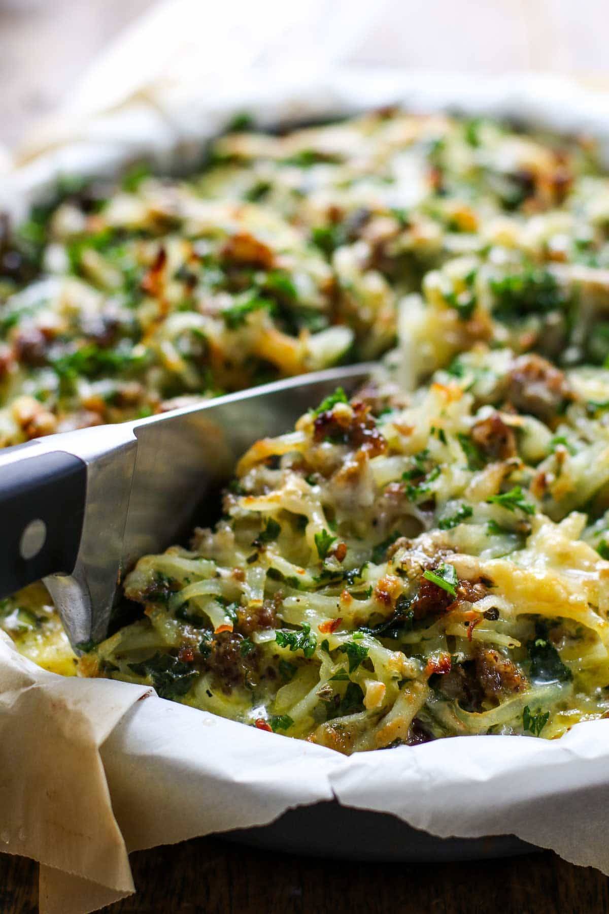Sausage Potato Pie with a knife.