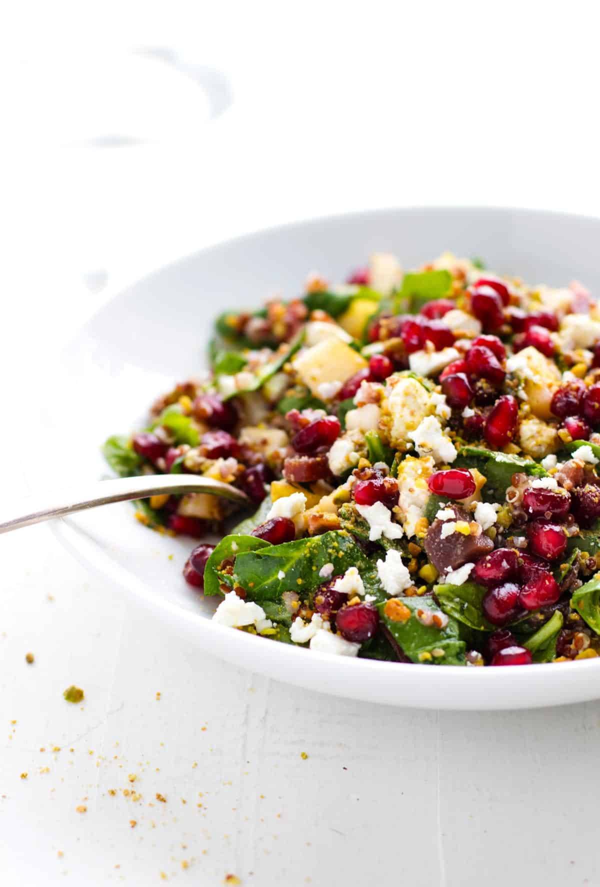 Rainbow Quinoa Salad on a white plate with a fork.